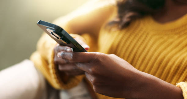 istock Hands, connection and using phone in home for scroll, typing and text message on sofa in living room. Female person, network and mobile app for creating profile, chat and explore on dating website 2166842003