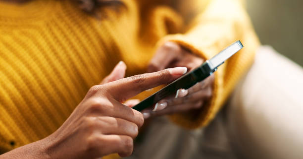 istock Hands, connection and smartphone in home for scroll, typing and text message on couch in living room. Female person, network and mobile app for creating profile, chat and explore on dating website 2166842010