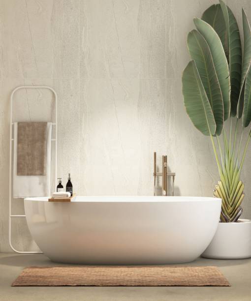 istock White freestanding bathtub in sunlight from window on stone tile wall bathroom with tropical banana tree 2166842671