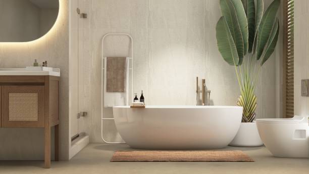 istock White freestanding bathtub, shower enclosure, vanity counter in sunlight from window on tile wall bathroom with tropical tree 2166842674