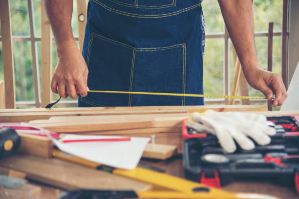 istock DIY craftsperson asian man working wood heap carpenter objects woodwork desk. Architect man hands use ruler measure hammer home improvement. Wooden builder carpenter repairing construction workshop 2166844748