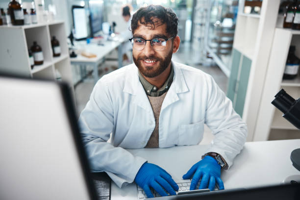 istock Laptop, science and smile with man in laboratory for development, innovation or research. Computer, pharmaceuticals and report with happy scientist at work on medical breakthrough or discovery 2166845277