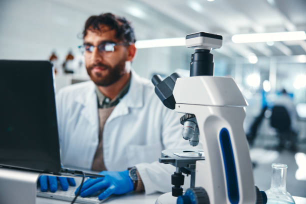 istock Laptop, microscope and science with man in laboratory for development, innovation or research. Computer, online study and pharmaceuticals with scientist at work on medical breakthrough or discovery 2166845290
