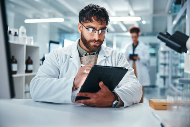 istock Report, science and tablet with man in laboratory for development, innovation or research. Pharmaceuticals, study and technology with serious scientist at work on medical breakthrough or discovery 2166845294