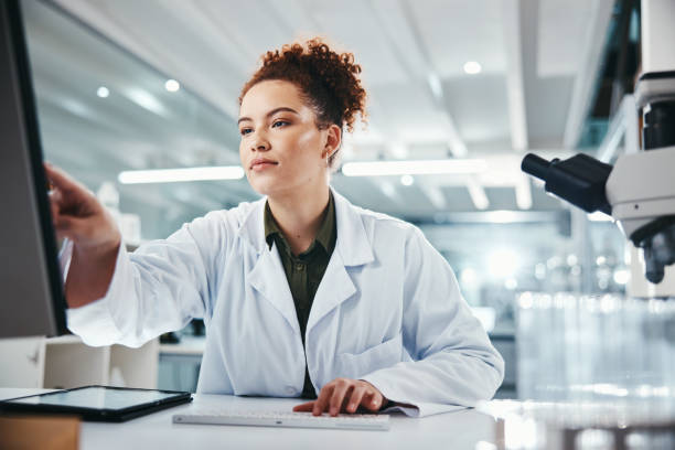 istock Computer, pointing and science with woman in laboratory for development, innovation or research. Pharmaceuticals, report or review and scientist at work on medical breakthrough, discovery or feedback 2166845351