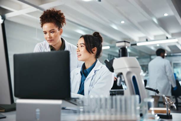 istock Laptop, science and smile with women in laboratory for development, innovation or research. Computer, pharmaceuticals and study with scientist team at work on medical breakthrough or discovery 2166845359