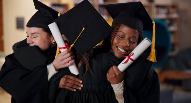 istock Graduation, achievement or students hug with certificate at university for education, opportunity or success. College, scholarship or group of people at school campus with knowledge, smile or diploma 2166845747