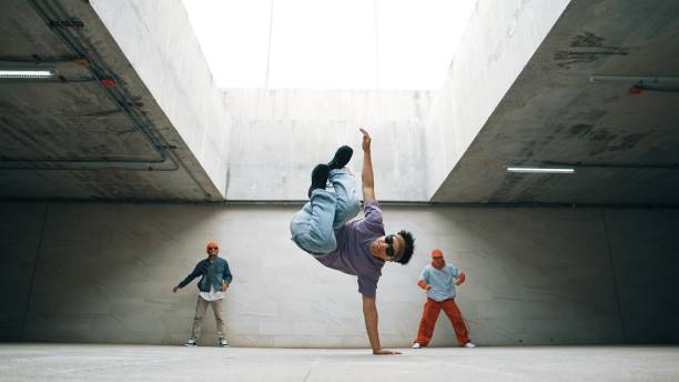 istock Group of stylish hipster group perform dancing together in building. Sprightly. 2166846296