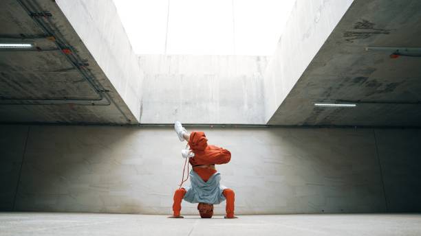 istock Dancing man enjoy practice break dance or freestyle in building. Sprightly. 2166846917