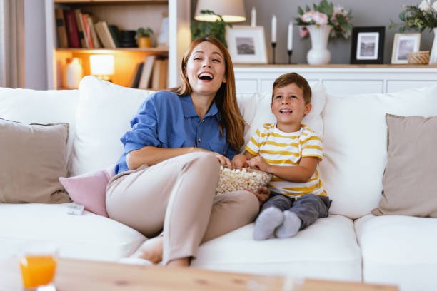 istock Happy mother and son laughing on a white cozy couch 2166847015