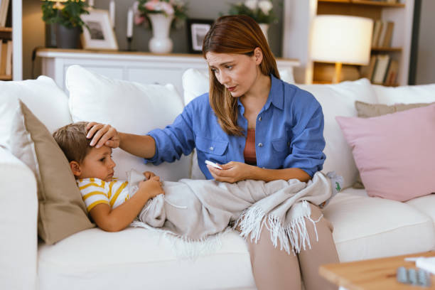 istock Mother checking temperature of her sick child. 2166847037