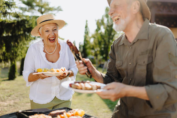 istock Senior couple grilling meat and enjoying in the backyard 2166847708