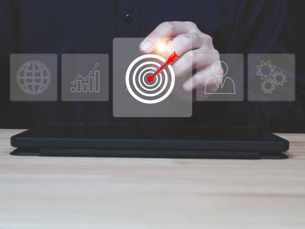 istock Businessman using laptop and tablet showing business growth target icon 2166847790