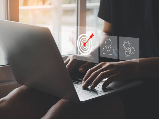 istock Businessman using laptop and tablet showing business growth target icon 2166847797