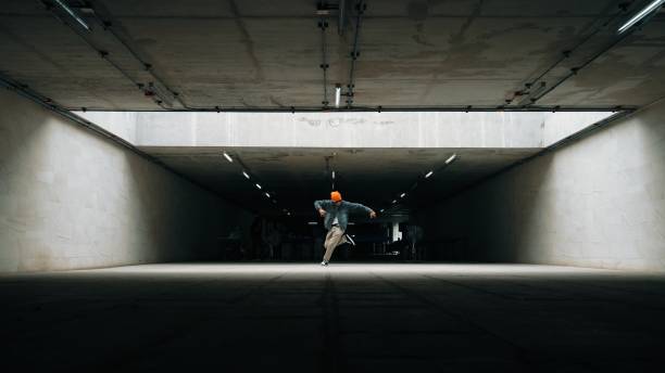 Blurred image of a dynamic runner in red pants ascending stairs, capturing the concept of motion and fitness in an urban environment. Vibrant lighting emphasizes shadows and architectural details.