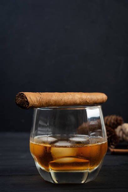 istock Glass of whiskey with ice on dark background 2166848650