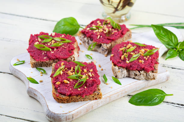 Toasts with beetroot, chopped nuts and herbs. Vegan bruschetta with beet