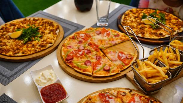 istock Pizza and Fries on a Restaurant Table 2166852693