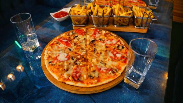 istock Pizza and Fries on a Blue Tabletop 2166853202