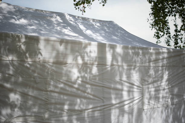 White tent. Tent for trading in the park. White tent. Stretched tent.