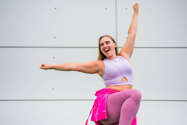 istock Young woman dancing outdoors 2166854709