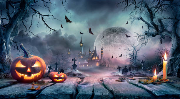 istock Halloween Scene - Pumpkin On Wooden Table In Graveyard At Moonlight - - Contain Unrecognizable, Deformed And Defocused Church With Reassembled Part 2166855991