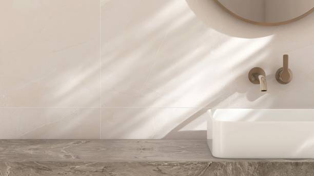 White ceramic rectangle washbasin on marble stone vanity bathroom counter in sunlight