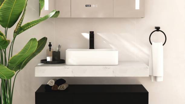 istock White ceramic rectangle washbasin on marble vanity bathroom counter, black faucet in sunlight, green tropical banana tree 2166856783