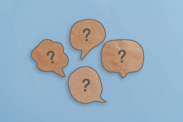 istock Question mark on brown real speech bubbles grunge paper cut with blue background 2166856988
