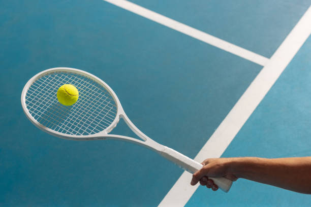 istock Hand holding a racquet and balancing a ball on it 2166856998