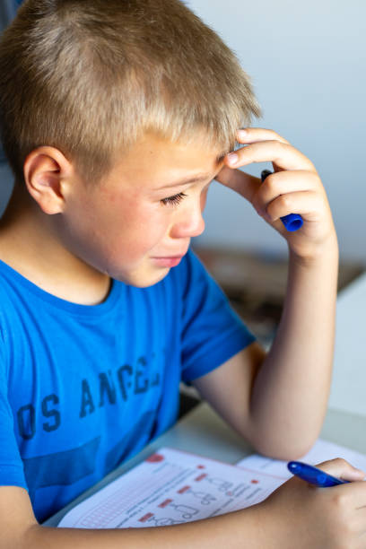 istock A boy in a blue T-shirt is crying over school 2166857061