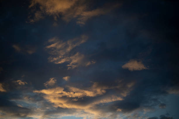 The evening sky. The setting sun illuminated the clouds. The light on the clouds. Details of the weather.