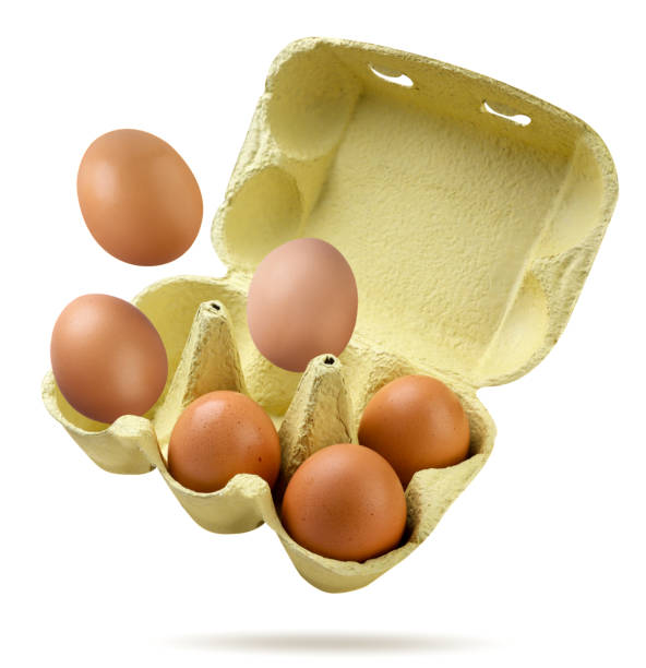 istock Chicken eggs flying out of a box on a white background. Isolated 2166859792