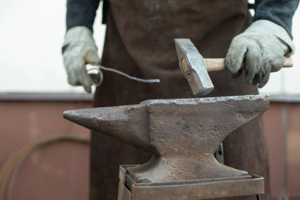 Blacksmith and Anvil. Hammer blow. Anvil on farm.