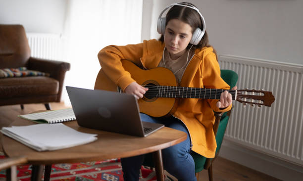 istock Focused Beginner Guitarist Practices at Home 2166860982