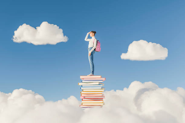 istock Woman Standing on a Stack of Books in the Clouds Looking Ahead 2166861032