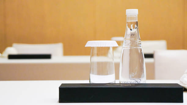 istock Two tables, water bottle, two glasses, white tablecloth, black box. 2166861313