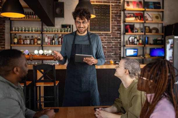 istock Waiter taking orders from customers in a pub 2166862724