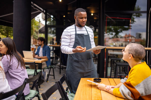 istock Waiter taking an order from a customer in a pub 2166863889