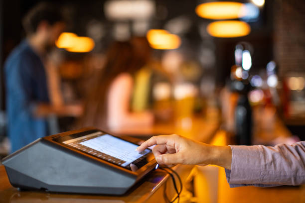 istock Woman using a digital cash register 2166864285
