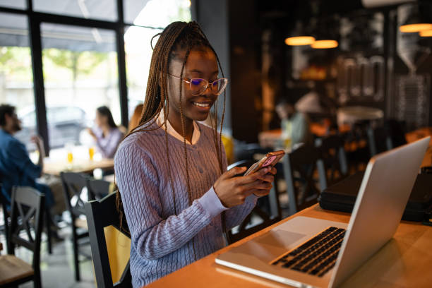 istock Young woman working on a laptop in a pub 2166864614