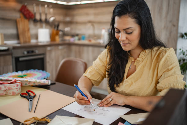 Woman creating handmade crafts in a modern kitchen during daylight hours