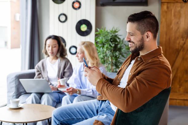 istock Group of young people working in a modern co-working space and using technology 2166869059