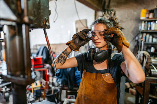 istock Young Woman Putting On Protective Eyewear Before Working On A Drill Press In A Metal Workshop 2166870668