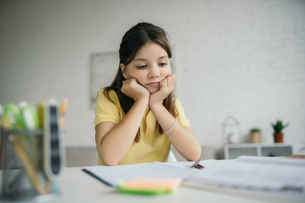 istock Little girl focused on her remote learning journey at home in a cozy study setting 2166870682