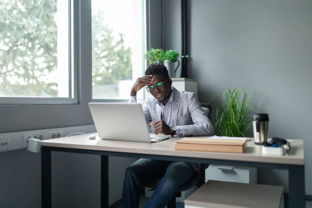 istock Young man exhausted from working in the office 2166870907