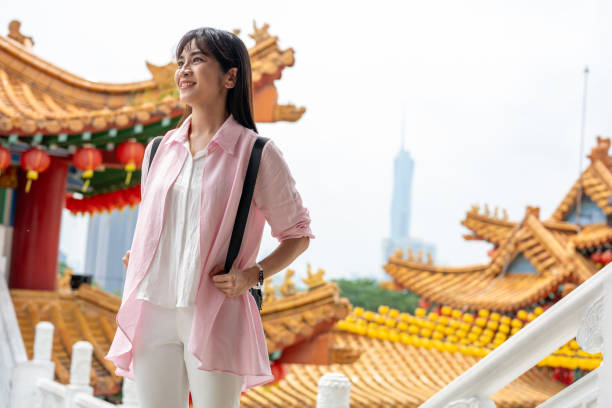 Portrait of an Asian female tourist enjoying sightseeing at Thean Hou Temple, Kuala Lumpur, Malaysia.