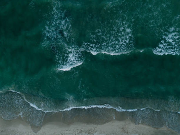 istock Tranquil ocean waves and sandy beach, showcasing pristine nature from a birds eye view 2166873877