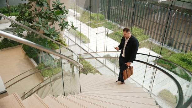 istock Skilled businessman analyzing marketing report data from mobile phone. Urbane 2166874050