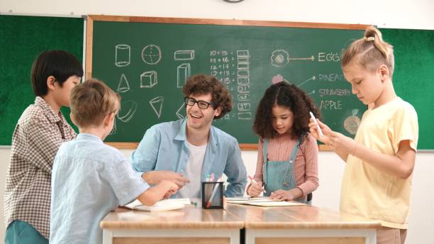 istock Smart teacher explain idea while diverse children drawing mind map. Pedagogy. 2166875508